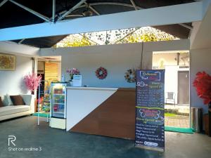 a store with a counter with a sign in a room at Hotel 41 Maribaya in Tegal