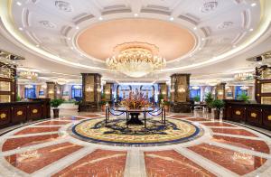 a lobby with a chandelier and a table at Wyndham Garden Haikou South in Haikou +115 photos