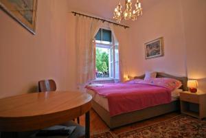 a bedroom with a bed and a table and a window at Studio Park in Sarajevo