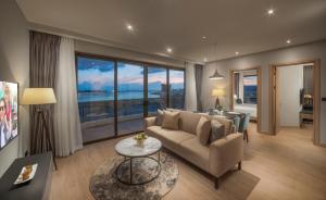 a living room with a couch and a table at Citadines Marina Halong in Ha Long