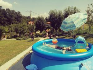 a person laying in a swimming pool in a inflatable at "Porodica MARKOVIC" Borsko jezero in Bor