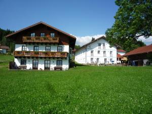 a large green field in front of a house at Ferienhof Landhaus Michael in Böbrach