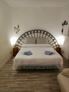 a bedroom with a large bed with two pillows on it at casa Tuccari Castiglione di Sicilia in Castiglione di Sicilia