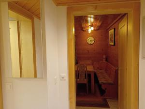 a dining room with a table and a clock on the wall at Chalet Adler in Grächen