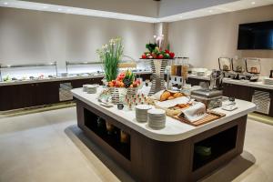 a large kitchen with a counter with food on it at Марциаль in Tyumen