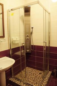 a shower with a glass door in a bathroom at Прага in Krasnodar
