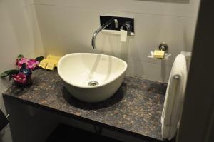 a bathroom with a large white sink on a counter at Pride Biznotel Manjusar Vadodara in Vadodara