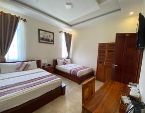 Voodi või voodid majutusasutuse Hoang Quan Hotel toas
