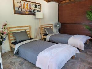 A bed or beds in a room at Fuerte Action Guest House