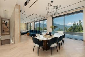 a dining room and living room with a table and chairs at Villa Mandragora in Kotor