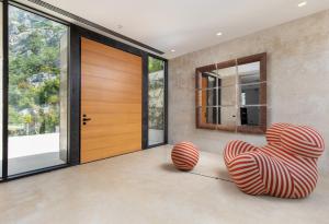 a room with two chairs in front of a door at Villa Mandragora in Kotor