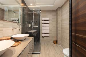 a bathroom with two sinks and a glass shower at Villa Mandragora in Kotor +32 photos