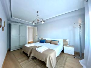 a bedroom with a large white bed with two pillows at Housingleón San Isidoro in León