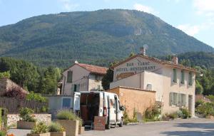 a white van parked in front of a building at Le Coq en Pâte in La Roque-Esclapon