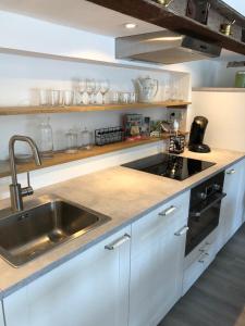 a kitchen with a sink and a counter top at Hoeve op de Meer in Maastricht