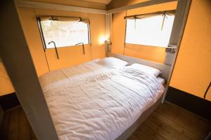 A bed or beds in a room at Glamping Le Tegole
