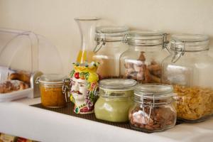 a shelf with jars of food in a refrigerator at La Guitgia Rooms in Lampedusa