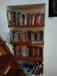a book shelf filled with lots of books at The Pepper Cottage in Gomagoda +30 photos