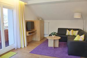 a living room with a couch and a table at Haus Bergland in Pfronten