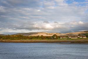 a large body of water with mountains in the background at Monks Ballyvaughan in Ballyvaughan