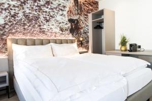 Ein Bett oder Betten in einem Zimmer der Unterkunft Adaastra Boutique Hotel