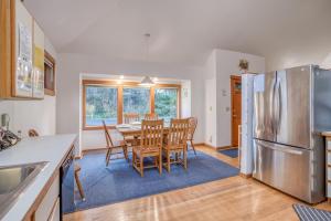 a kitchen and dining room with a table and a refrigerator at Driftwood Cottage MCA 491 - Meredith Lodging in Manzanita +30 photos
