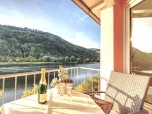 a bottle of wine sitting on a table on a balcony at Ferienhaus Bullay in Bullay