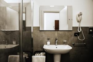 a bathroom with a sink and a mirror at Travel B&B in Bari