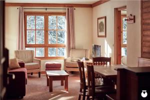 a living room with a table and chairs at Tartiflat, Arc1950, 2 bed, Ski in Ski out, Arc 1950 in Bourg-Saint-Maurice
