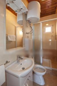 a white bathroom with a sink and a toilet at Studio apartment in Tucepi with sea view, balcony, air conditioning, WiFi 3674-4 in Tučepi
