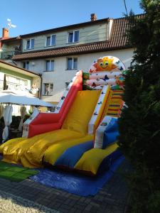 a inflatable playground with a slide in front of a building at Oaza Łeba - Doskonały dla rodzin z dziećmi! in Łeba