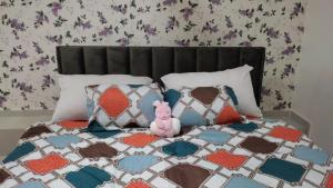a bed with a pink stuffed animal sitting on it at Sleeps 2 - Pet Friendly with Garden & Parking in Bortianor