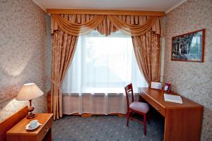 a hotel room with a desk and a window at GTK Suzdal in Suzdal