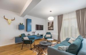 a living room with a blue couch and chairs at Villa Clara in Labinci
