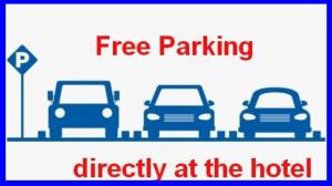 a sign that reads free parking directly at the hotel at Hotel Montha in Chiang Mai