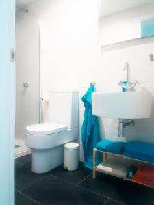 a bathroom with a white toilet and a sink at Apartment Tenerife Sur in Palm-Mar