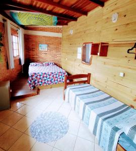 Ένα ή περισσότερα κρεβάτια σε δωμάτιο στο Hostel Aroeira do campo