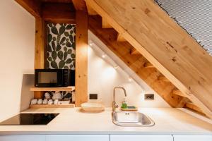 a kitchen with wooden ceilings and a sink at FICOPALA SUITES in Syracuse