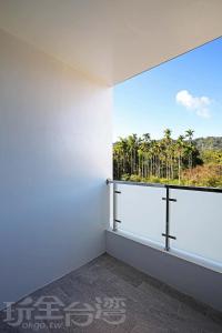a room with a large window with a view of palm trees at Riyuewan Homestay in Yuchi