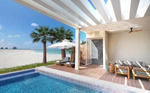 a villa with a swimming pool and a view of the ocean at InterContinental Ras Al Khaimah Mina Al Arab Resort & Spa, an IHG Hotel in Ras al Khaimah
