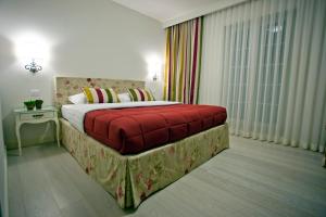 a bedroom with a large bed with a red blanket at Hotel Villa Grace in Međugorje
