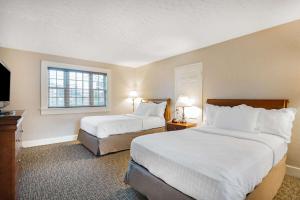 a hotel room with two beds and a window at Natural Bridge Hotel, Trademark Collection by Wyndham in Natural Bridge +170 photos