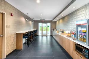 a fast food restaurant with a counter and chairs at Microtel Inn & Suites by Wyndham Farmington in Canandaigua