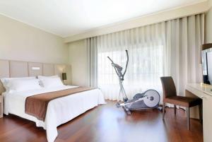 a hotel room with a bed and a vacuum at TRYP by Wyndham Porto Expo Hotel in Leça da Palmeira