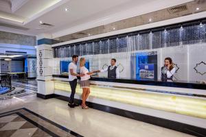 a group of people standing in front of a bar at Karmir Resort & Spa - Ultra All Inclusive in Kemer
