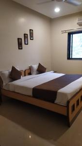 a bedroom with a large bed in a room at Aquarius Resort in Pune