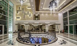 a lobby with a spiral staircase in a building at Karmir Resort & Spa - Ultra All Inclusive in Kemer