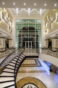 a spiral staircase in a building with a large window at Karmir Resort & Spa - Ultra All Inclusive in Kemer