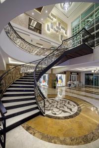 a spiral staircase in a building with a lobby at Karmir Resort & Spa - Ultra All Inclusive in Kemer