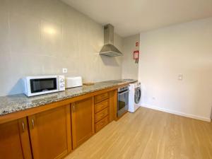 a kitchen with a counter top with a microwave at Baía dos Moinhos in Ribeira Grande